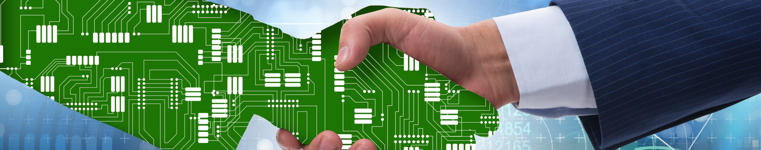 two hands shaking, one of which is made of computer chips.