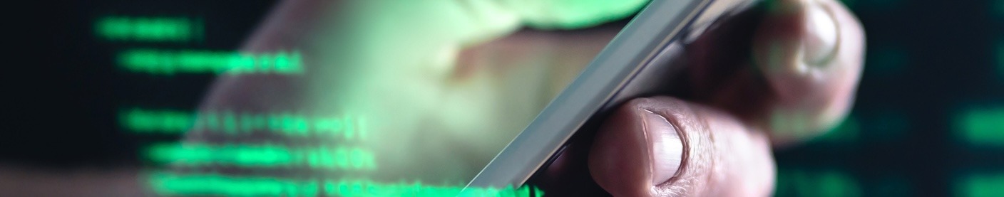 A hand holding a smart phone overlaid with green computer terminal text.